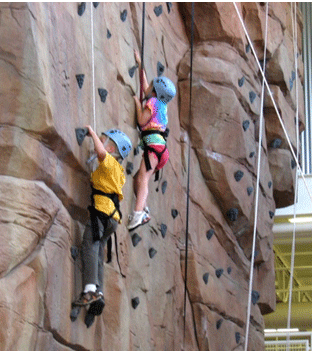 Children climbing rock wall