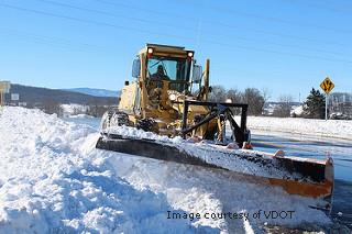 Image of a snow plow plowing snow off road