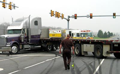 Officer walking towards tractor trailer