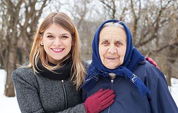 Image of young and elderly woman in winter