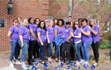 Photo of group and pinwheels planted to raise awareness about child abuse
