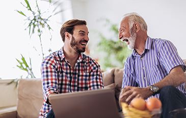 image of adult male and senior male laughing
