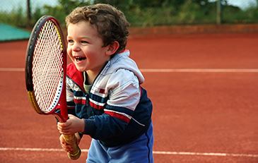 image of child with tennis racket
