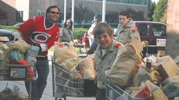 Boy Scouts push carts of donations